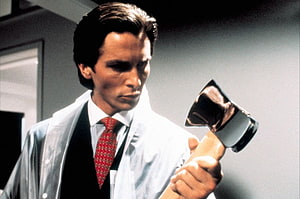 Patrick Bateman from American Psycho holding an axe in a white coat and red tie, American Psycho, patrick bateman HD wallpaper