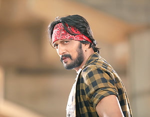 Kiccha Sudeep in a red bandana and checkered shirt with a rugged beard HD wallpaper