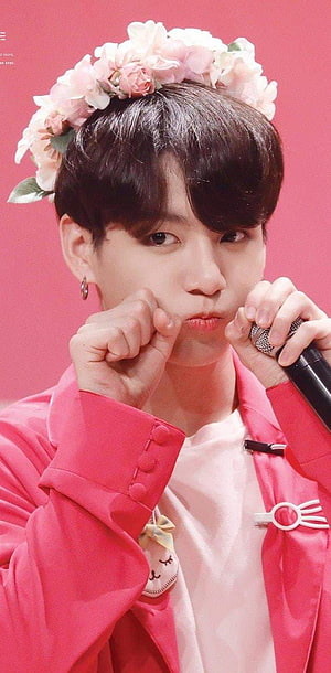 V from BTS wearing a pink floral crown and jacket posing with a microphone HD phone wallpaper