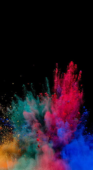 Vibrant multicolored powder explosion bursting against a deep black background HD phone wallpaper