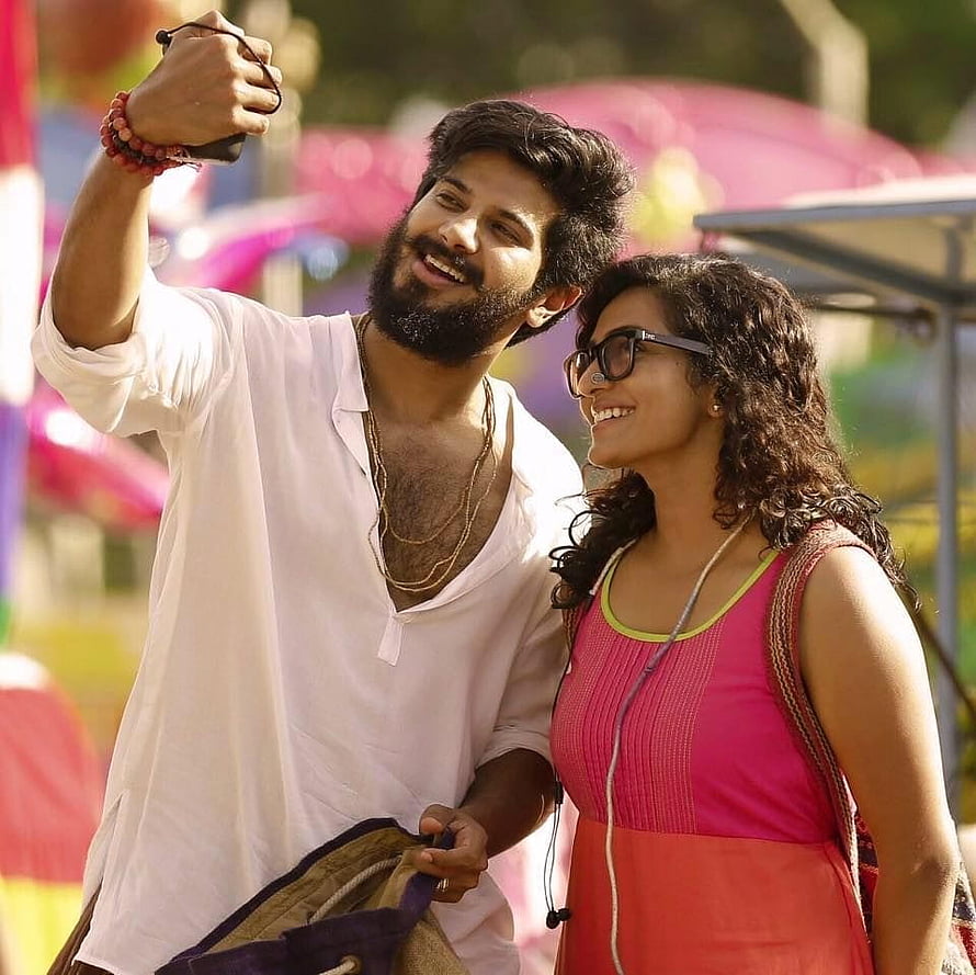 Dulquer Salmaan and Charlie in a cheerful outdoor selfie moment from a Malayalam film HD wallpaper