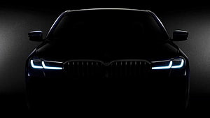 BMW 7 Series Front View With Illuminated LED Headlights In Dark Atmosphere HD wallpaper