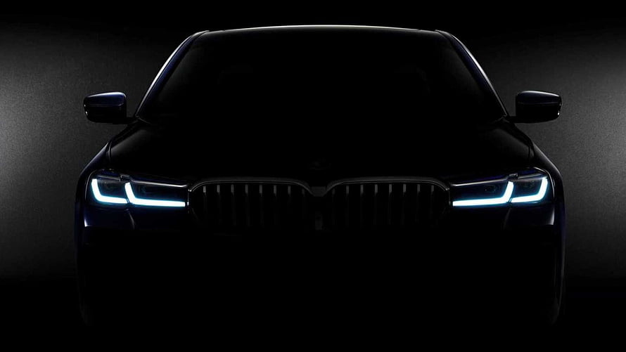 BMW 7 Series Front View With Illuminated LED Headlights In Dark Atmosphere HD wallpaper
