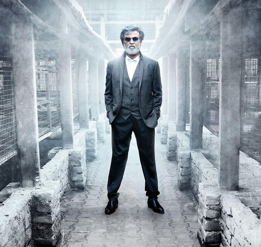 Rajinikanth in a grey three-piece suit and sunglasses standing in a foggy industrial corridor from the film Kabali HD wallpaper