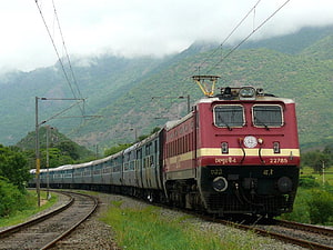 Indian Railways WAP-4 Electric Locomotive Hauling Passenger Train Through Scenic Mountainous Landscape HD wallpaper