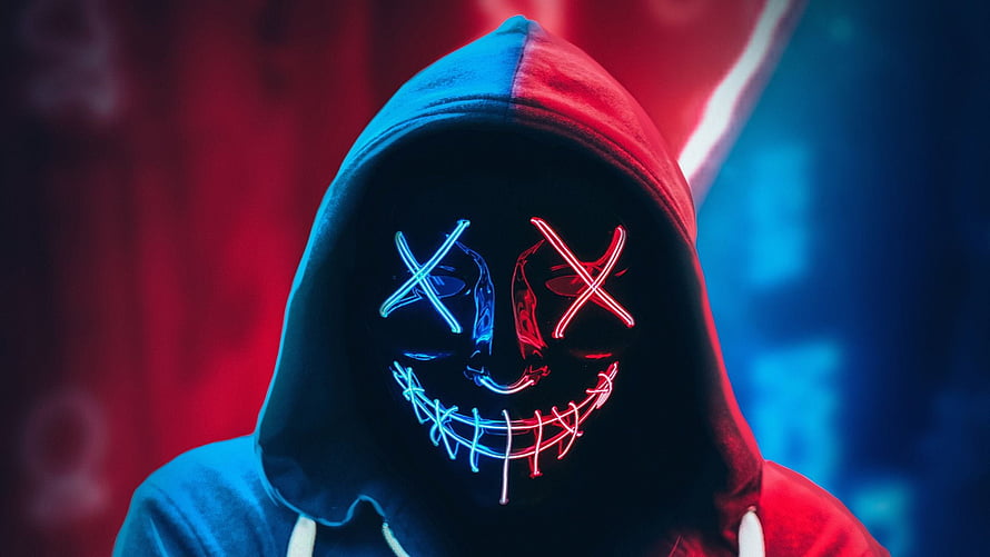 Mysterious Hooded Figure Wearing Glowing Neon Smile Mask in Red and Blue Light HD wallpaper