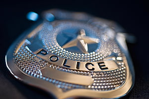 Close-Up of Shiny Silver Police Badge with Star Emblem on Dark Background HD wallpaper
