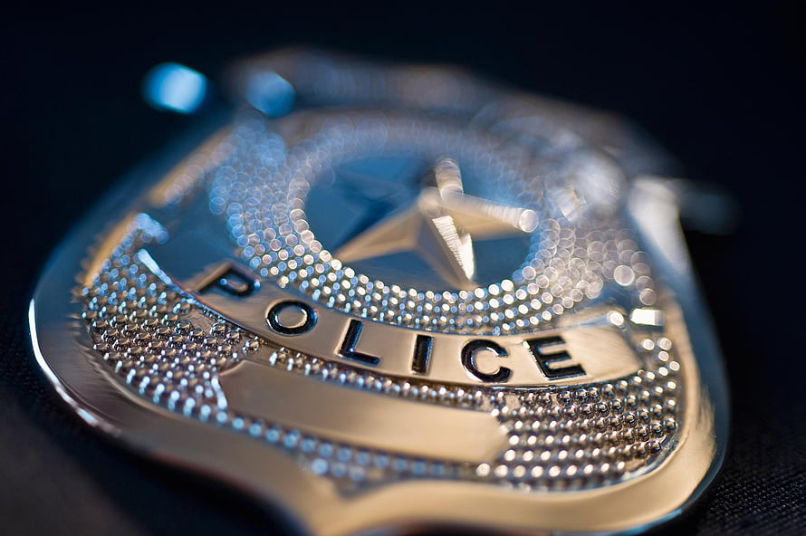 Close-Up of Shiny Silver Police Badge with Star Emblem on Dark Background HD wallpaper