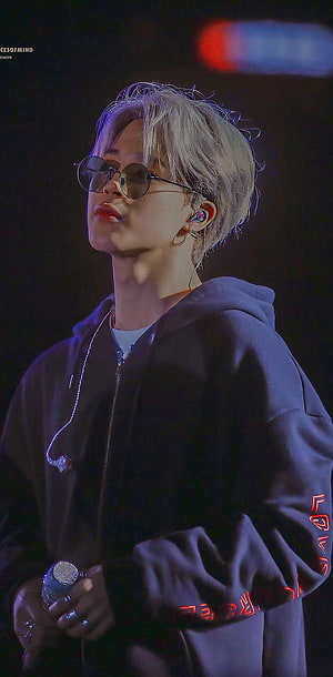 Jimin from BTS performing on stage in a dark hoodie and round sunglasses HD phone wallpaper