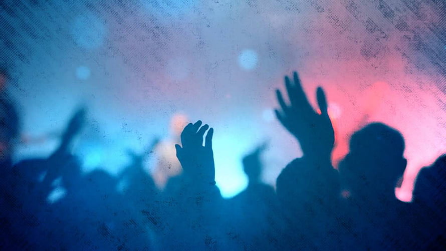Silhouetted Worship Crowd With Raised Hands Against Blue and Pink Stage Lights HD wallpaper