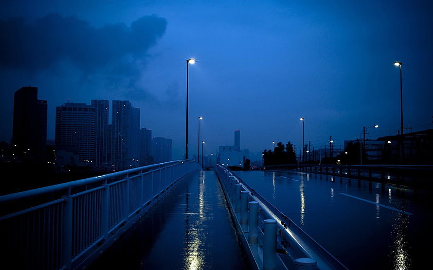 Moody Blue Night Cityscape on Wet Bridge with Streetlights HD wallpaper
