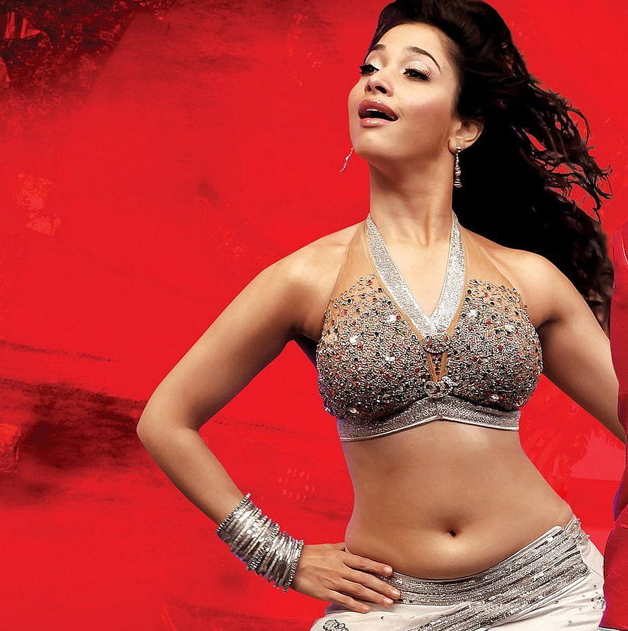 Tamanna Bhatia in Sparkling Silver Dance Costume Against Vibrant Red Background HD phone wallpaper