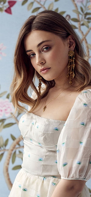 Josephine Langford in White Floral Dress with Gold Chandelier Earrings HD phone wallpaper