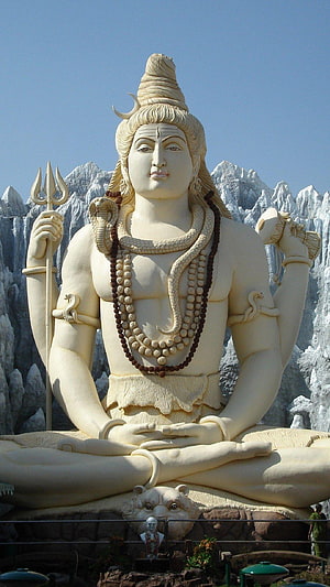 Majestic White Statue of Lord Shiva Meditating with Trishul and Snake HD phone wallpaper