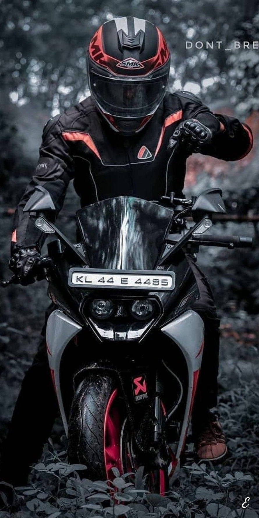 KTM Rider in Full Black and Red Gear on a Sport Motorcycle in a Forest Setting HD phone wallpaper