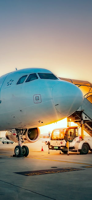 Commercial Airplane Nose at Airport Tarmac During Golden Hour Sunrise HD phone wallpaper
