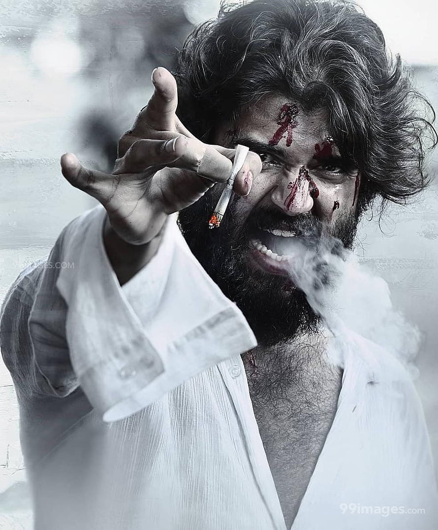 Pawan Kalyan as Bheema in the Telugu action film Bheeshma, smoking a cigarette with blood on his face HD phone wallpaper
