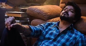 Vikram Vedha Movie Still Featuring Madhavan in Blue Plaid Shirt Relaxing on Sofa HD wallpaper