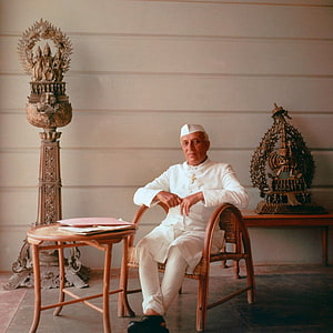 Jawaharlal Nehru Seated in White Attire with Traditional Indian Decorative Artifacts HD phone wallpaper