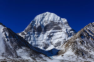 Mount Kailash Snow-Capped Peak in Tibet Under a Deep Blue Sky HD wallpaper