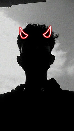 Silhouette Portrait With Glowing Red Devil Horns Against Overcast Sky HD phone wallpaper