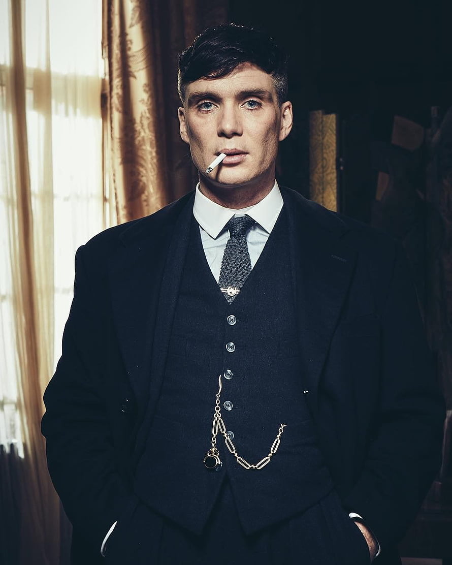 Cillian Murphy as Thomas Shelby in a dark suit with a cigarette and pocket watch chain HD phone wallpaper