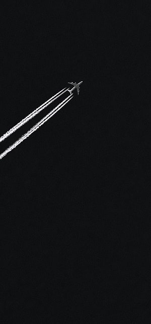 Minimalist Airplane Silhouette with Contrails Against a Dark Night Sky HD phone wallpaper