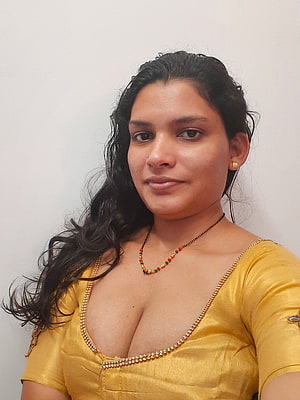 Portrait of a woman wearing a yellow traditional blouse with gold jewelry and a beaded necklace against a white background, Resmi R Nair []: Latest , Stills of Resmi R Nair, #resmi r nair HD phone wallpaper