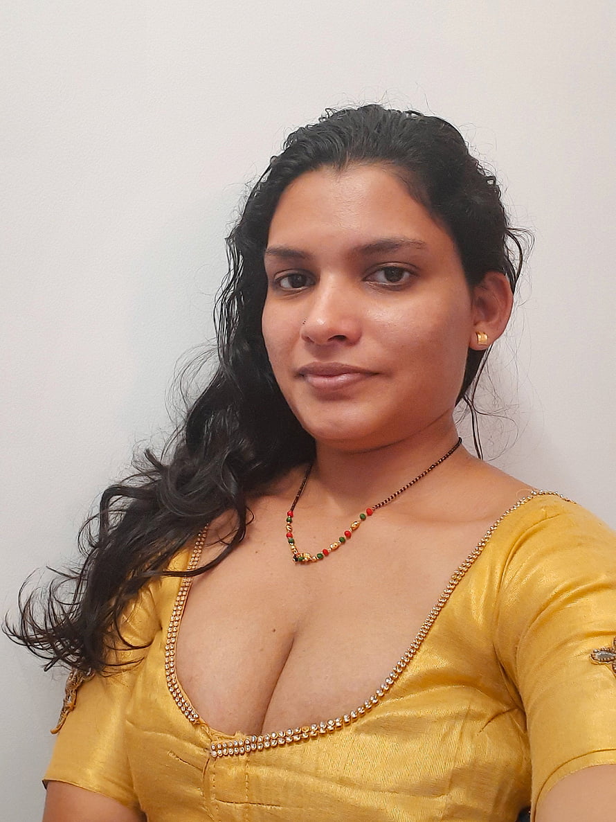 Portrait of a woman wearing a yellow traditional blouse with gold jewelry and a beaded necklace against a white background, Resmi R Nair []: Latest , Stills of Resmi R Nair, #resmi r nair HD phone wallpaper