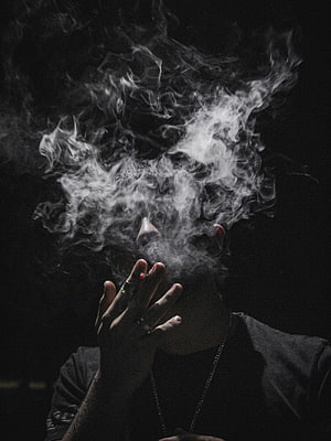 Moody Portrait of a Young Man Exhaling Thick Smoke Against a Dark Background, Smoking Boy, cigarette boy HD phone wallpaper