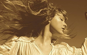 Taylor Swift in flowing white blouse with windblown hair in warm sepia portrait HD wallpaper