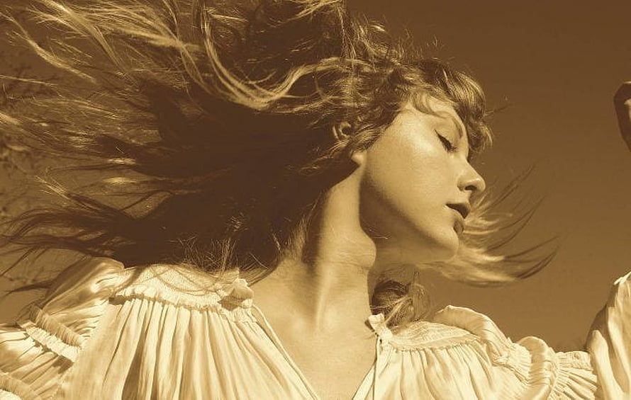 Taylor Swift in flowing white blouse with windblown hair in warm sepia portrait HD wallpaper