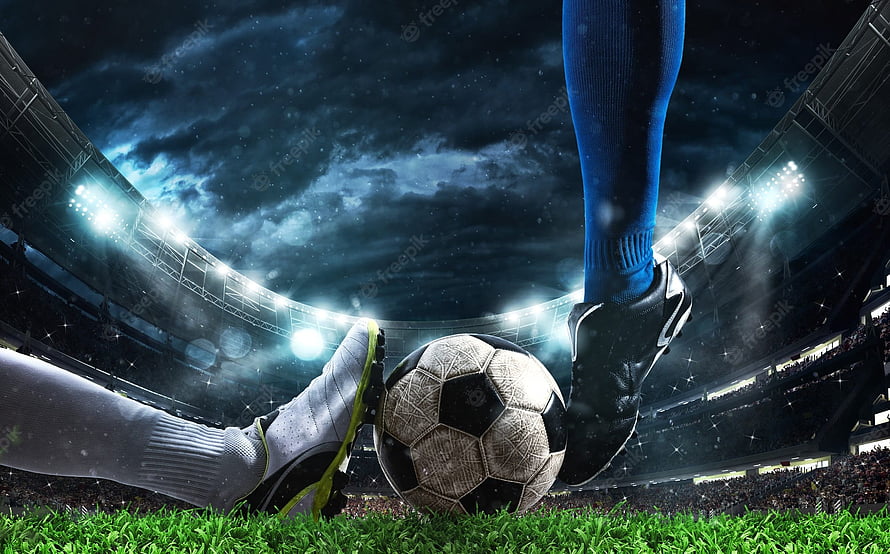Dramatic Soccer Match Scene with Player Kicking Ball Under Stadium Floodlights HD wallpaper