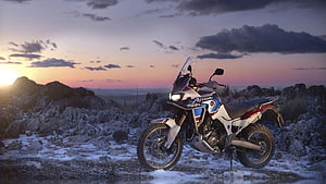 Honda Africa Twin Adventure Motorcycle Parked on Rocky Terrain at Sunset HD wallpaper