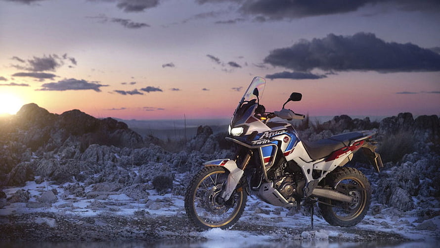 Honda Africa Twin Adventure Motorcycle Parked on Rocky Terrain at Sunset HD wallpaper