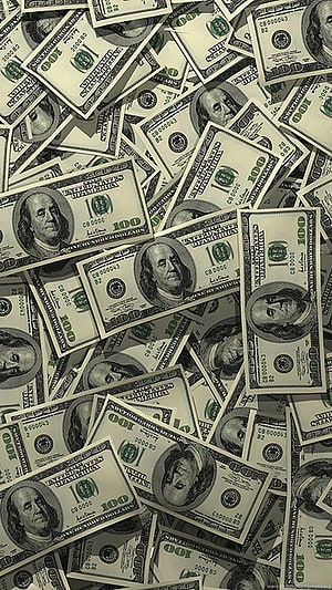 Scattered pile of one hundred dollar bills featuring Benjamin Franklin portrait HD phone wallpaper