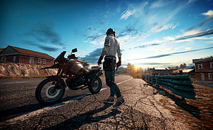 PlayerUnknown's Battlegrounds Rider Walking Away From Motorcycle On Deserted Road At Sunset HD wallpaper