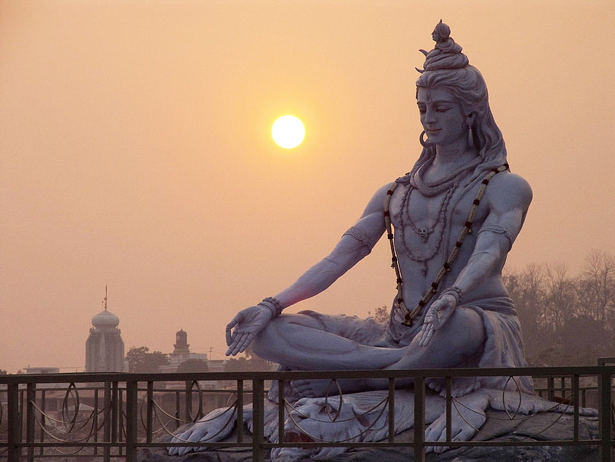 Lord Shiva Statue in Meditation at Sunset with Temple Silhouette HD wallpaper