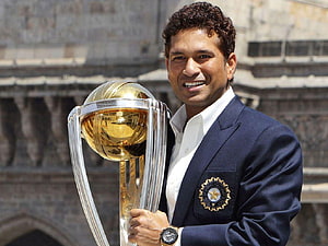 Sachin Tendulkar holding the ICC Cricket World Cup trophy in a blue blazer HD wallpaper