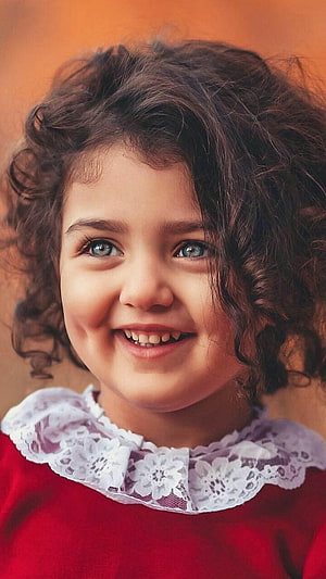 Portrait of a Smiling Girl with Curly Hair and a Red Dress with White Lace Collar HD phone wallpaper