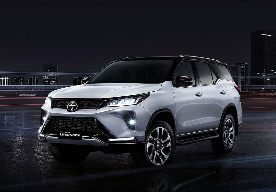 Silver Toyota Fortuner Legender SUV Parked on Wet City Street at Night HD wallpaper