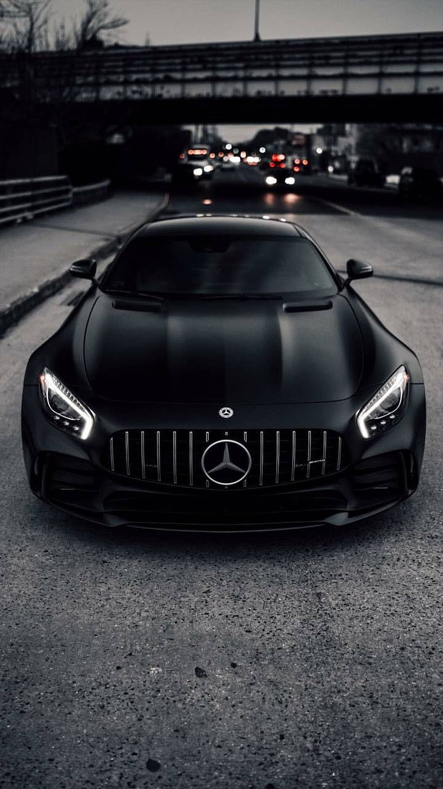 Matte Black Mercedes-AMG GT S Front View on Urban Highway at Dusk HD phone wallpaper