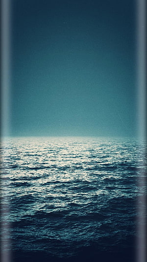 Serene Blue Ocean Horizon With Vintage Film Grain Texture And Soft Light HD phone wallpaper