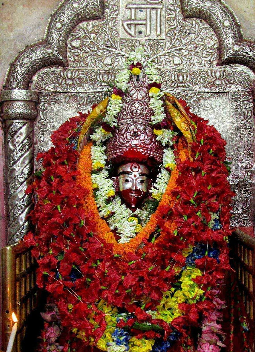 Decorated Hindu Deity Statue Adorned with Red Flower Garlands and Silver Crown HD phone wallpaper