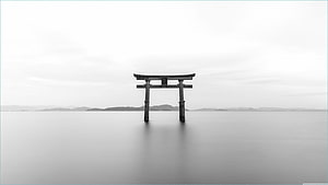 Serene Black And White Torii Gate Standing In Calm Water With Distant Mountains HD wallpaper