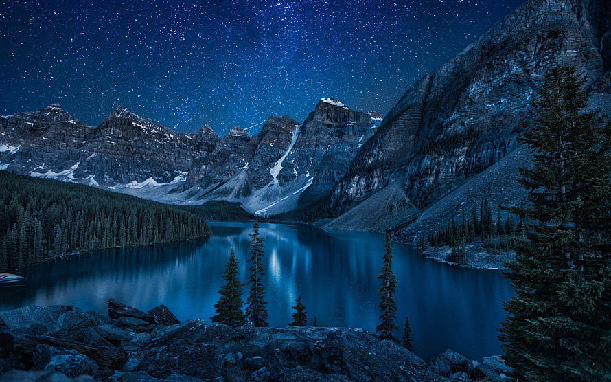 Starry Night Sky Over a Serene Mountain Lake with Snow-Capped Peaks and Pine Trees HD wallpaper