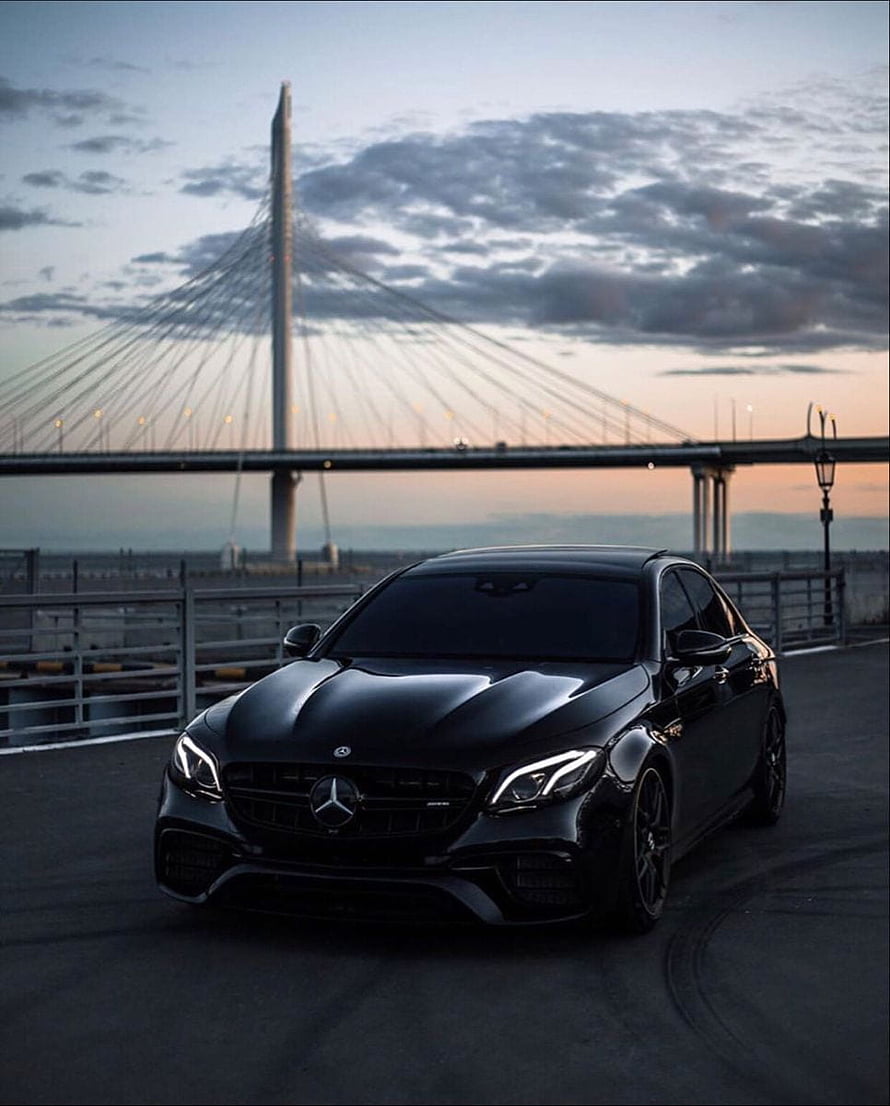 Black Mercedes-AMG C63 S Coupe Parked Near Cable-Stayed Bridge at Dusk HD phone wallpaper