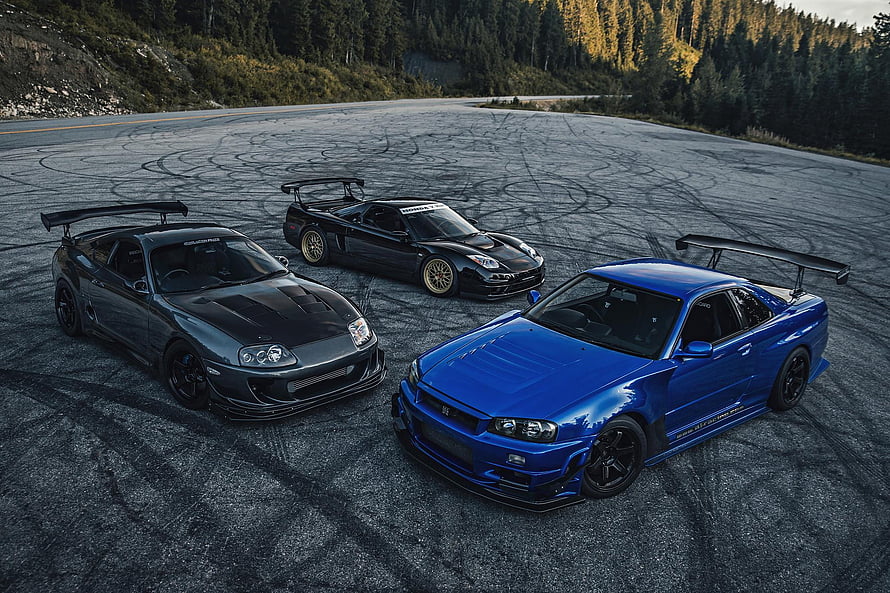 Three Modified JDM Supercars Parked on Asphalt Track with Forest Background HD wallpaper