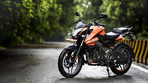 Bajaj Pulsar NS125 Orange Sport Bike Parked on Wet Forest Road HD wallpaper