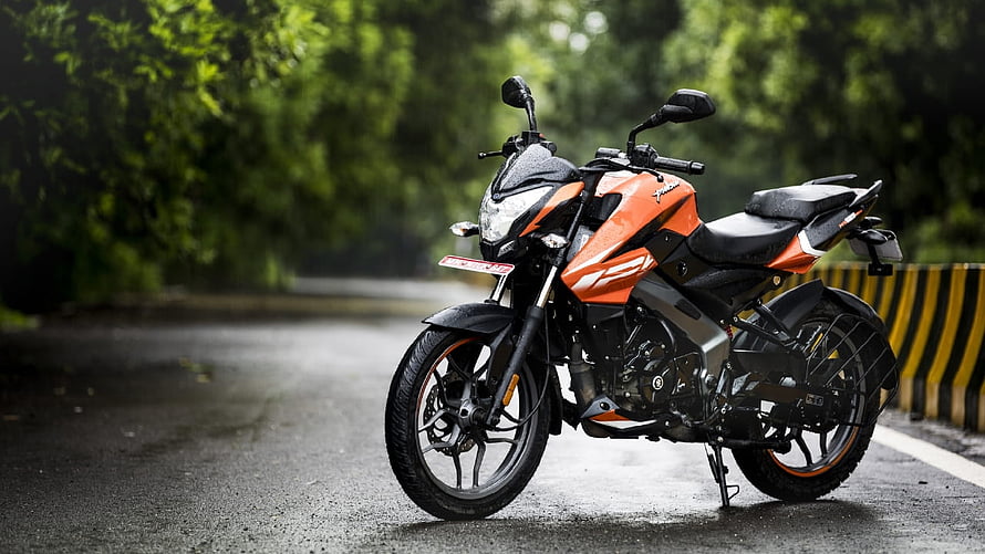 Bajaj Pulsar NS125 Orange Sport Bike Parked on Wet Forest Road HD wallpaper